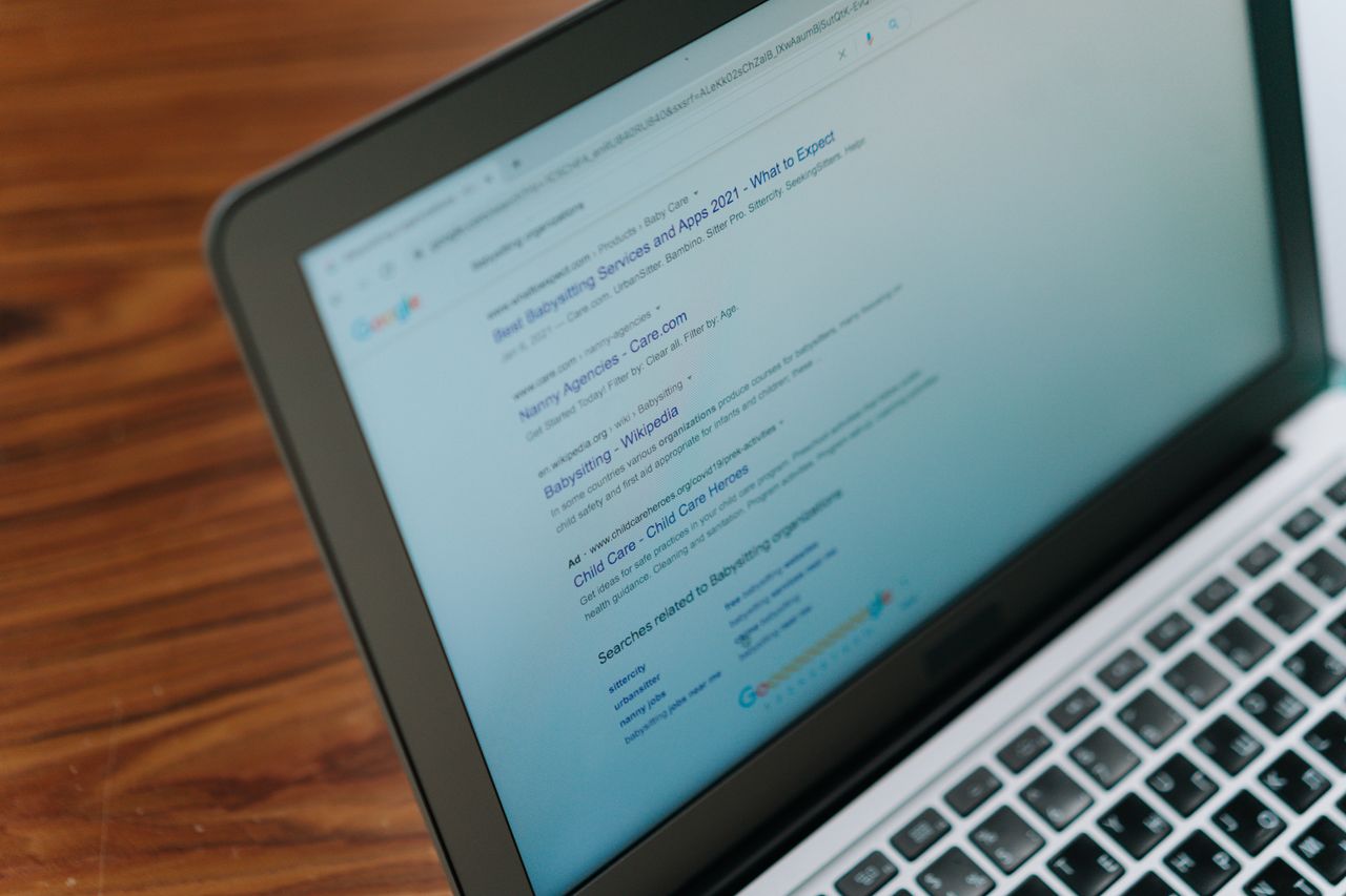 A close-up shot of a laptop screen showing a search engine results page.