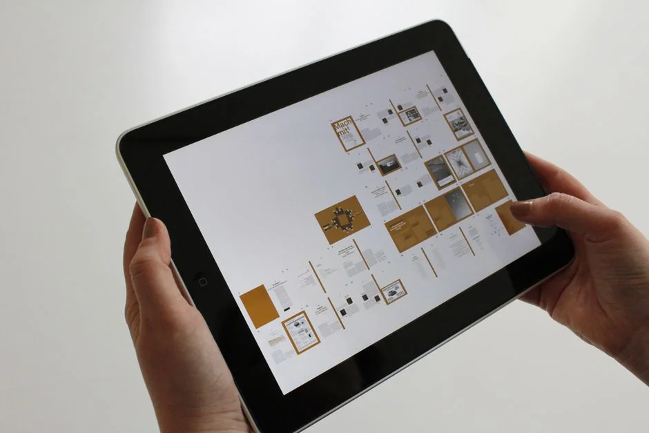 A tablet with a financial website open, alongside a white keyboard and mouse. Ideal for tech-theme stock images.